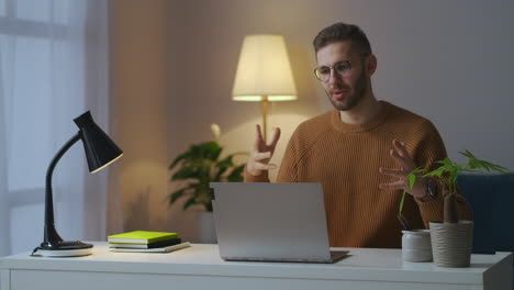 young-man-dressed-brown-sweater-is-welcoming-interlocutors-on-working-video-chat-online-conference-of-colleagues-person-is-working-from-home